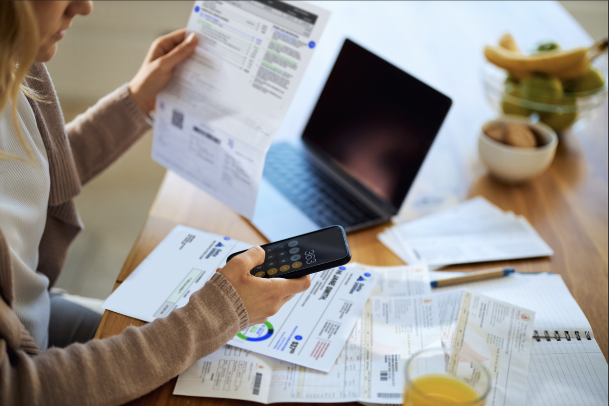 Woman reviewing her bill and calculating an average total
