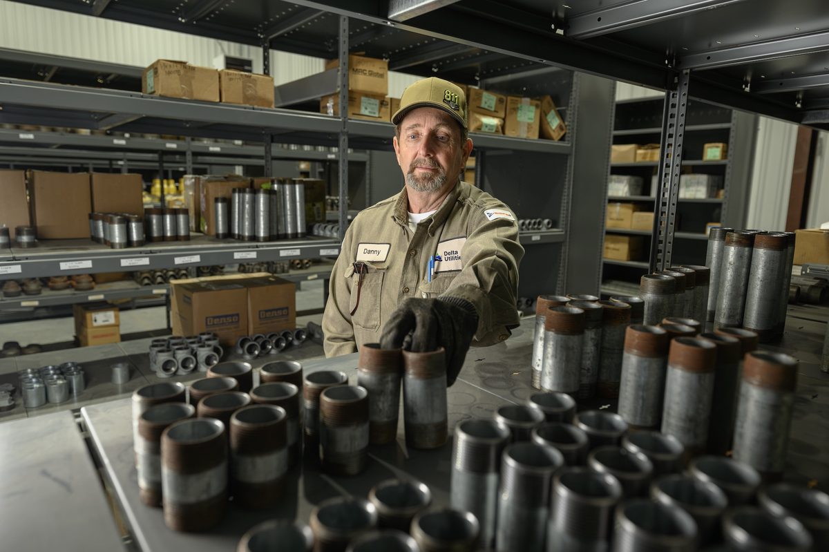 Delta Utilities Worker Selecting Parts to Fix an Issue