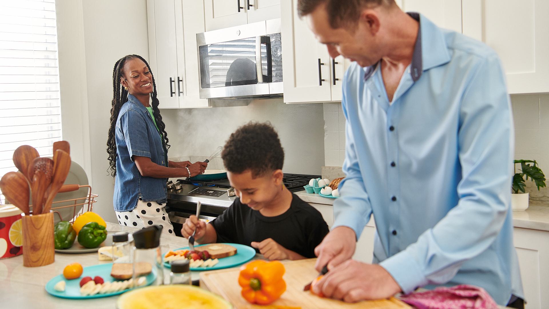 Family preparing breakfast together in a modern kitchen powered by natural gas.