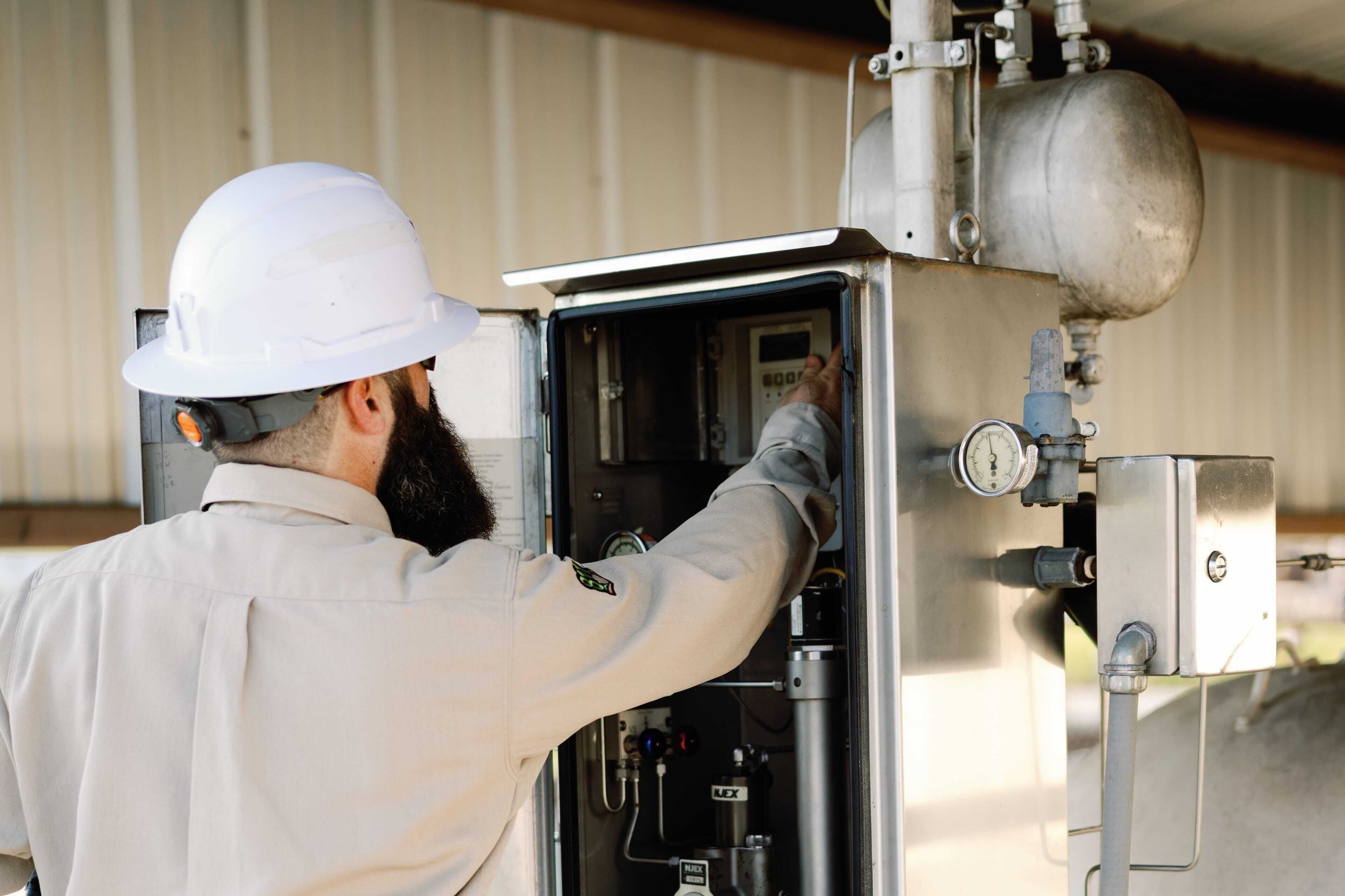 Delta Utilities Worker Adjusting a Gas Meter