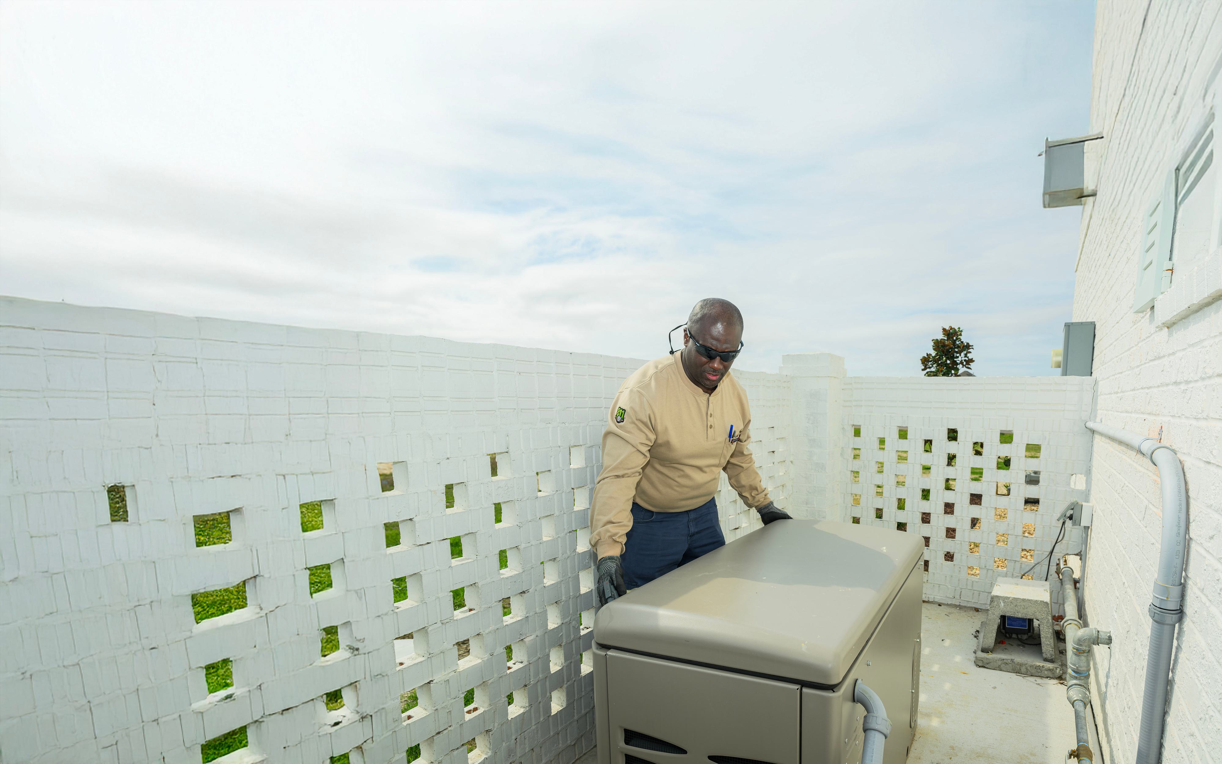 Delta Utilities worker servicing a generator powered by natural gas.